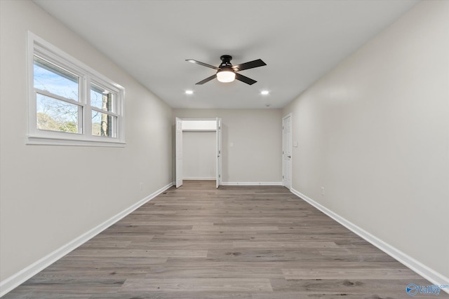 spare room featuring ceiling fan, baseboards, wood finished floors, and recessed lighting