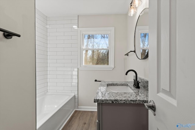 full bathroom featuring shower / bathtub combination, vanity, baseboards, and wood finished floors