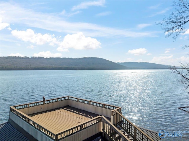 view of dock featuring a water and mountain view