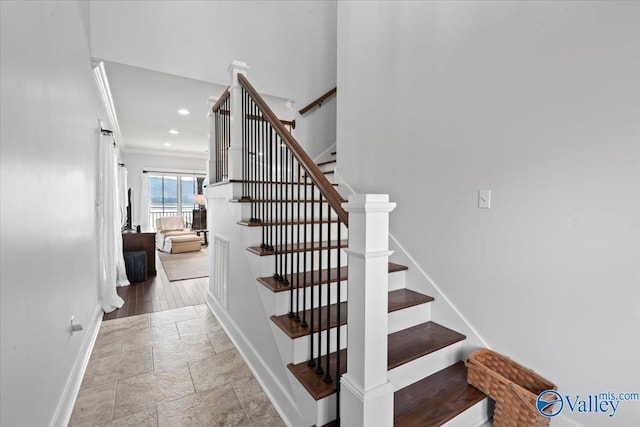 staircase featuring ornamental molding