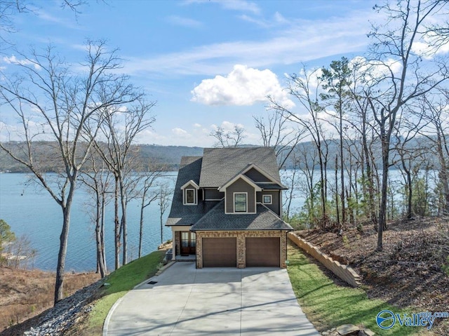 view of front facade featuring a water view and a garage