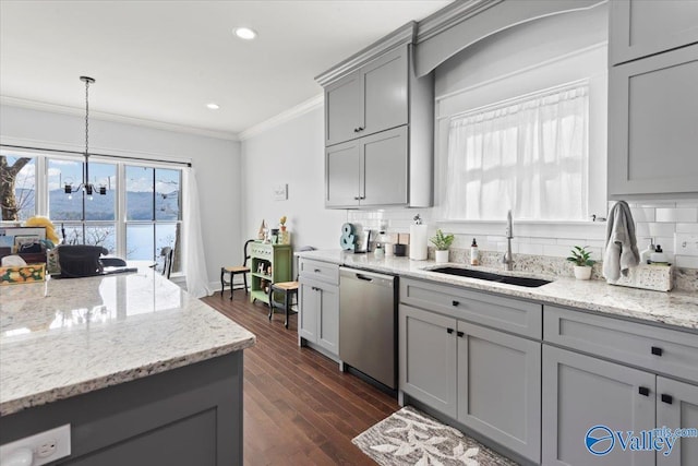 kitchen featuring pendant lighting, sink, gray cabinetry, stainless steel dishwasher, and light stone counters