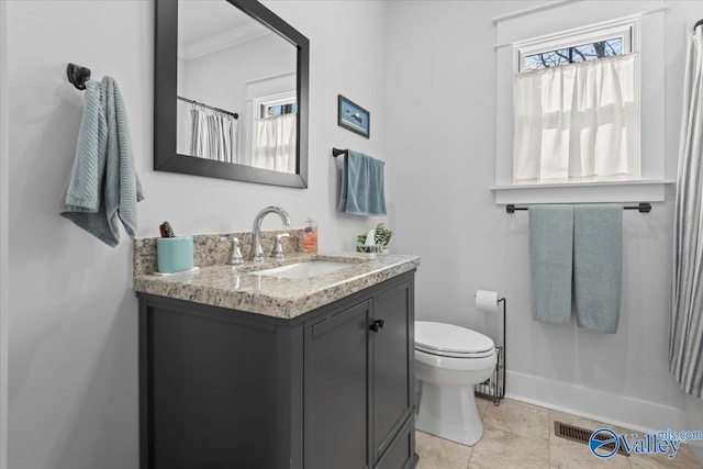 bathroom featuring vanity, crown molding, and toilet