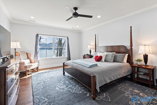 bedroom featuring dark hardwood / wood-style flooring, ornamental molding, and ceiling fan