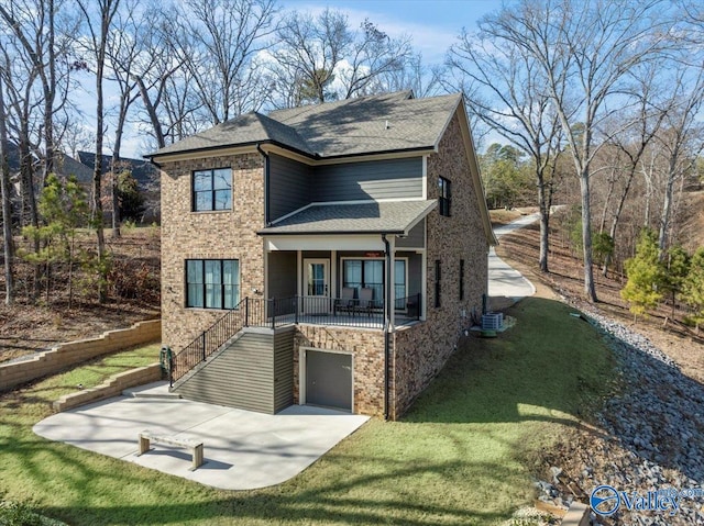 view of front of house featuring a garage, a front yard, and central air condition unit