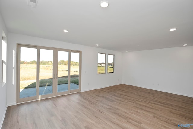 spare room with light hardwood / wood-style flooring