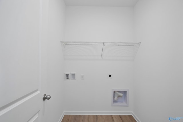 clothes washing area featuring hardwood / wood-style flooring, hookup for a washing machine, and electric dryer hookup