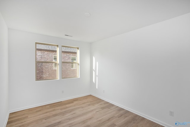 spare room with light hardwood / wood-style flooring