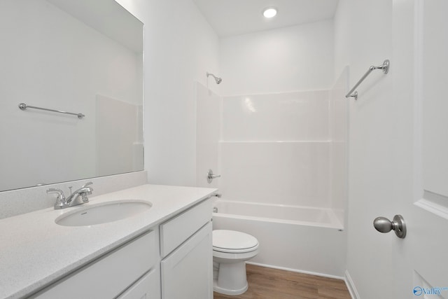 full bathroom featuring hardwood / wood-style flooring, vanity, toilet, and  shower combination