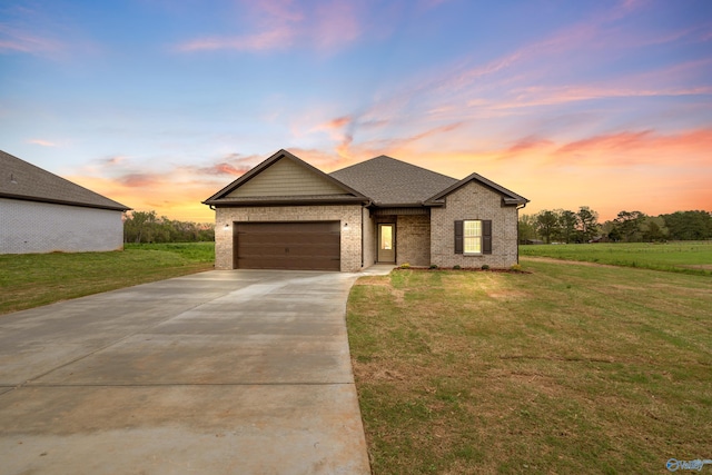 view of front facade with driveway, brick siding, a garage, a shingled roof, and a lawn