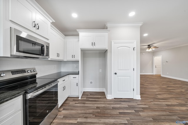 kitchen featuring crown molding, decorative backsplash, white cabinets, and stainless steel appliances