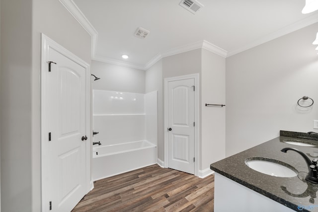 bathroom featuring a sink, visible vents, wood finished floors, and crown molding