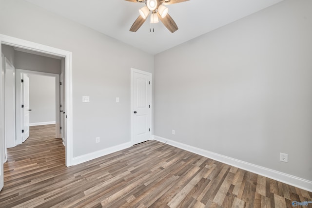 unfurnished bedroom with baseboards, a ceiling fan, and wood finished floors