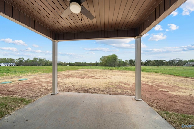 view of patio / terrace featuring a rural view and a ceiling fan