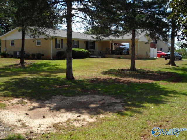 view of yard with central AC and a carport