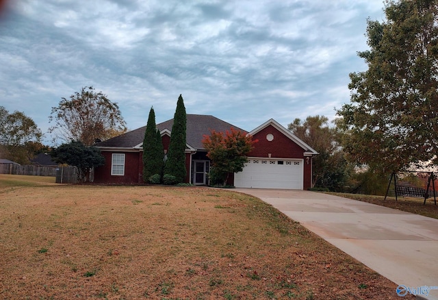 single story home with a front yard and a garage