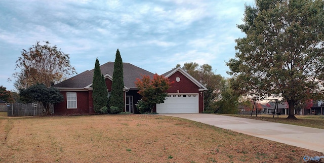 view of front of home with a garage and a front lawn