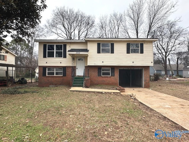 bi-level home with a garage and a front lawn