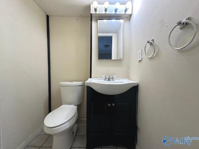 bathroom with tile patterned floors, vanity, and toilet