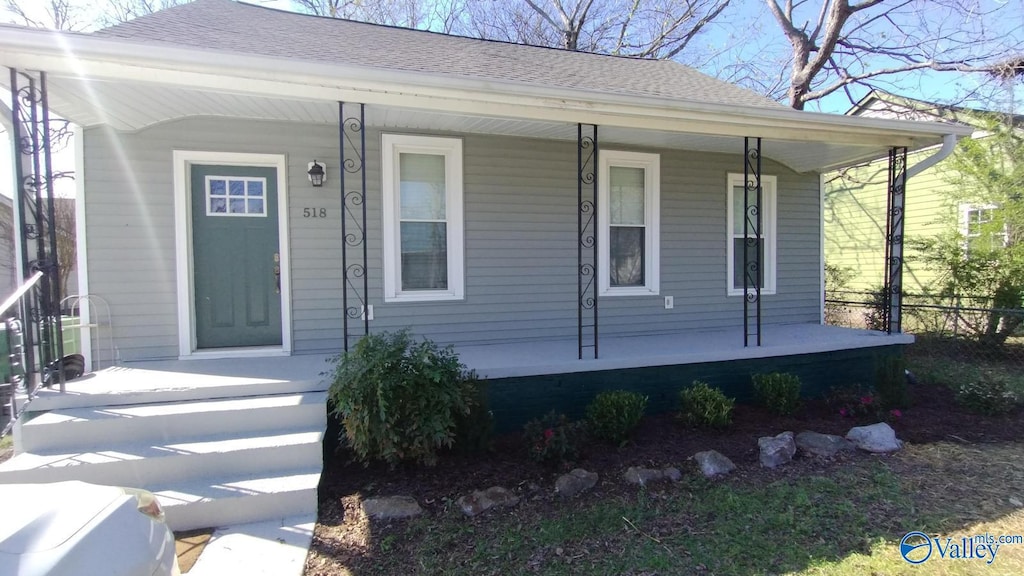 518 Stevens Ave NE, Huntsville, AL 35801 - view of front of home with a porch, roof with shingles, and fence