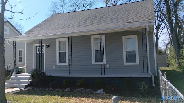 bungalow-style house with fence, a porch, and roof with shingles