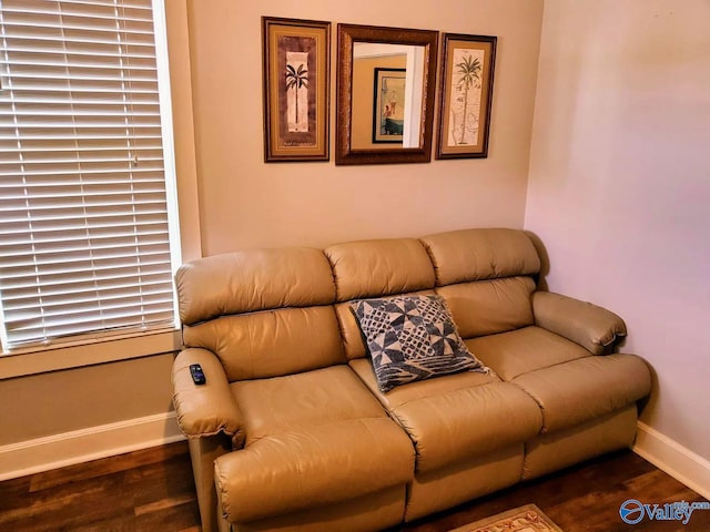 living area with baseboards and wood finished floors