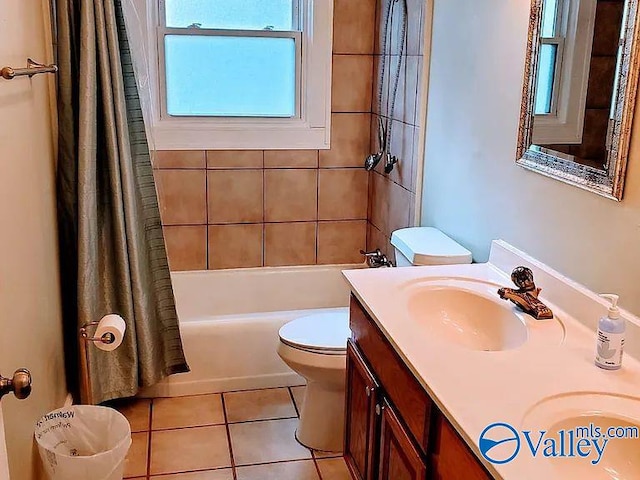 bathroom with vanity, tile patterned flooring, shower / bath combo with shower curtain, and toilet