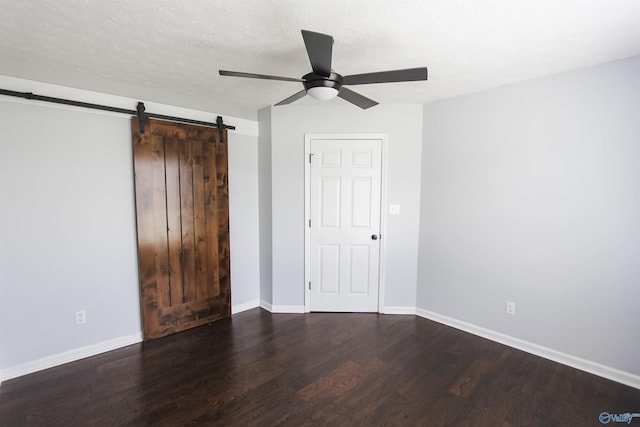 3790 Christopher Ave, Southside, AL 35907 - unfurnished bedroom with a textured ceiling, baseboards, ceiling fan, wood finished floors, and a barn door