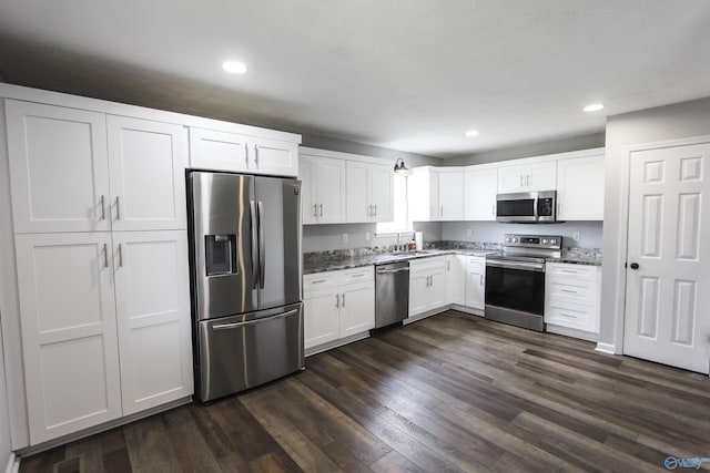 3790 Christopher Ave, Southside, AL 35907 - kitchen with dark wood-type flooring, dark stone countertops, white cabinets, and appliances with stainless steel finishes