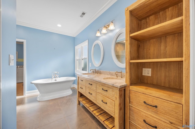 bathroom with ornamental molding, a washtub, vanity, tile patterned flooring, and washer / dryer