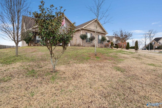 view of front of home featuring brick siding and a front lawn