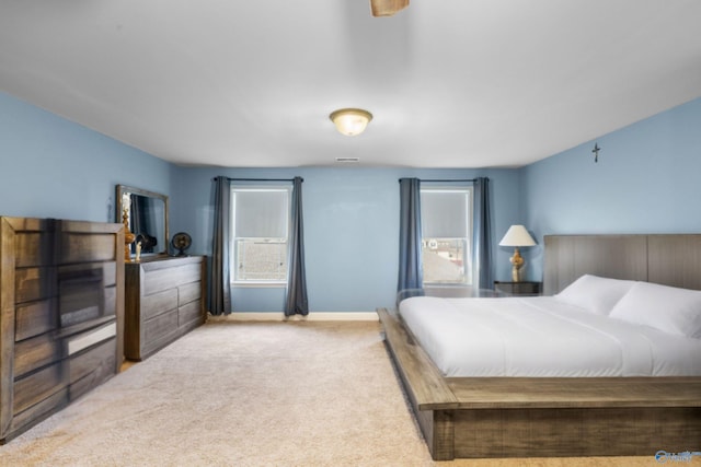 bedroom with multiple windows and carpet