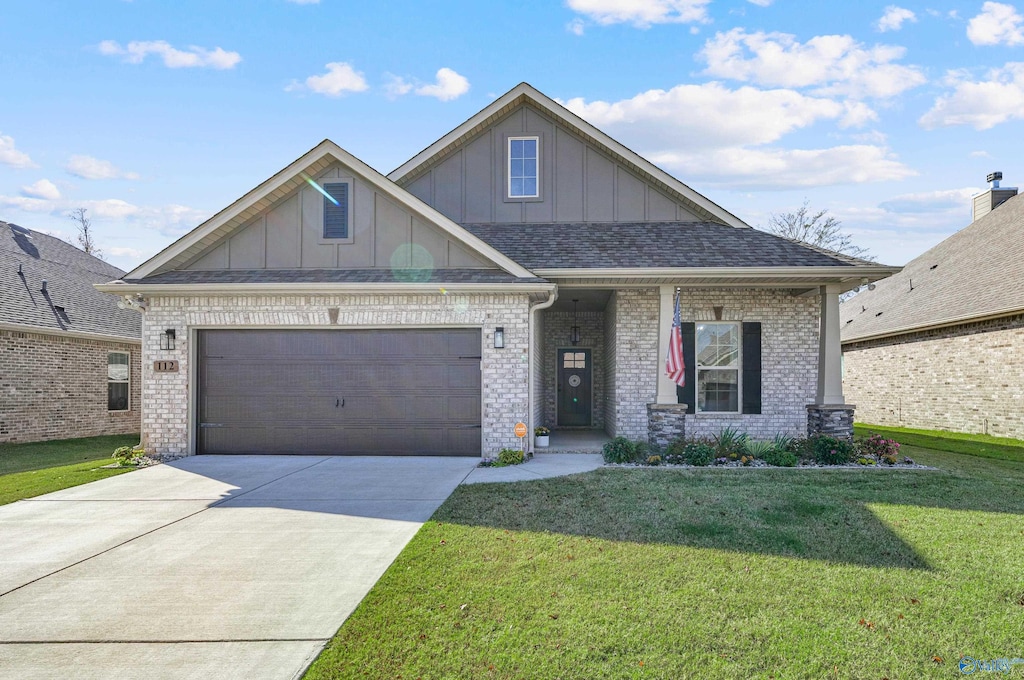 craftsman inspired home with a garage and a front yard