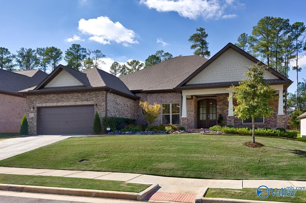 craftsman house featuring french doors, a garage, and a front lawn