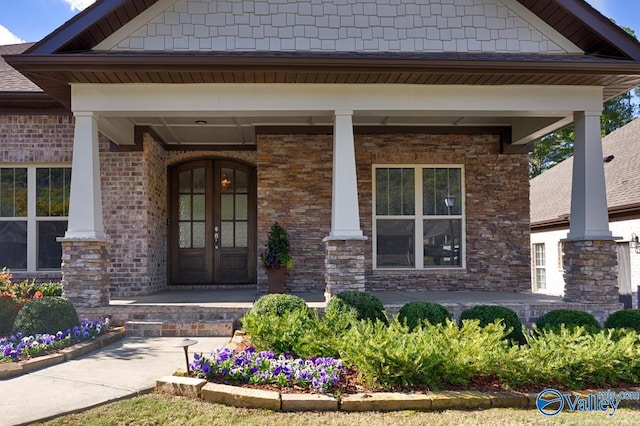 entrance to property with covered porch and french doors