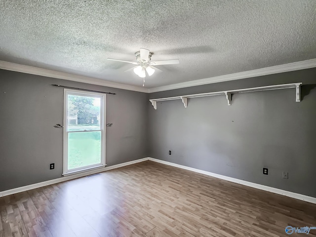 unfurnished room with a textured ceiling, ornamental molding, and hardwood / wood-style floors