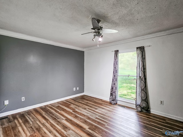 empty room with a textured ceiling, ornamental molding, hardwood / wood-style floors, and ceiling fan