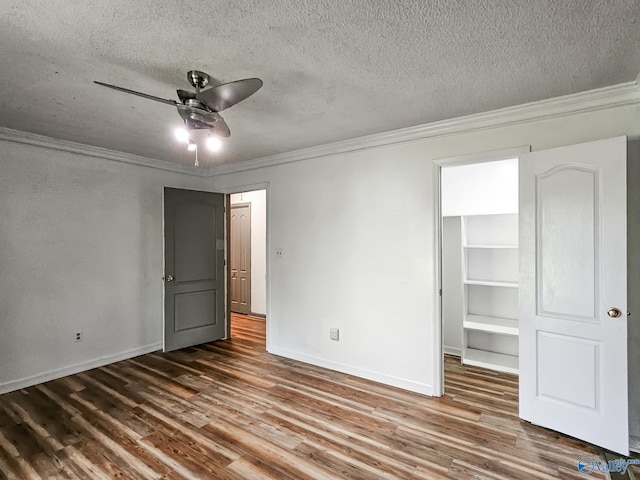 unfurnished bedroom featuring ceiling fan, hardwood / wood-style floors, and a textured ceiling