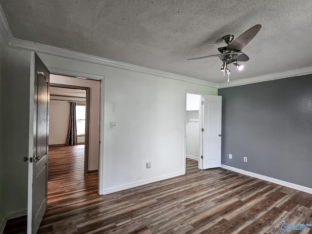 empty room with ornamental molding, a textured ceiling, ceiling fan, and dark hardwood / wood-style flooring