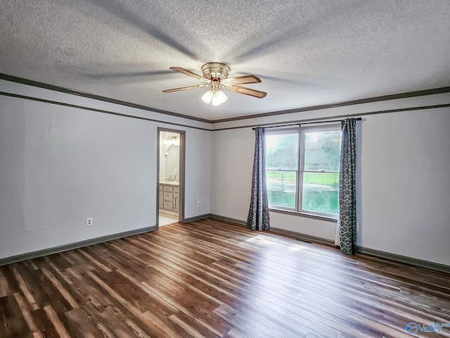 spare room featuring a textured ceiling, dark hardwood / wood-style floors, ceiling fan, and crown molding