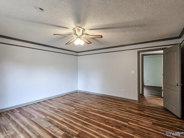 spare room with a textured ceiling, crown molding, dark hardwood / wood-style flooring, and ceiling fan