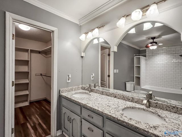 bathroom with wood-type flooring, a shower, crown molding, ceiling fan, and vanity