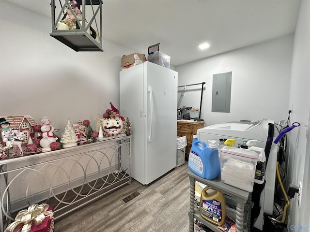 washroom featuring electric panel and light hardwood / wood-style flooring