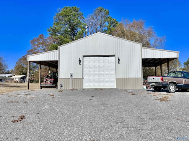 view of outbuilding with a carport and a garage