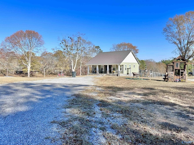 view of front facade with covered porch and a playground