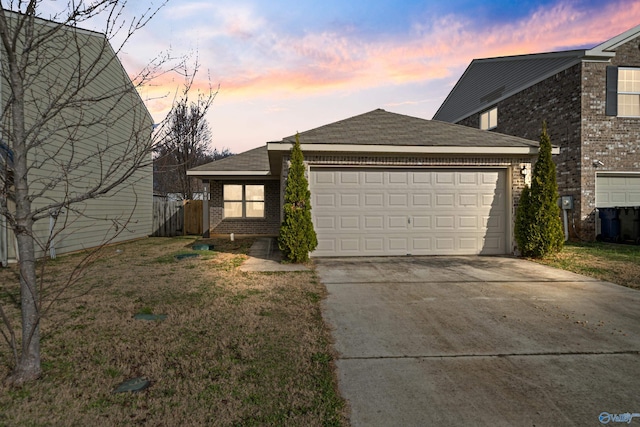 view of front of house with a yard and a garage