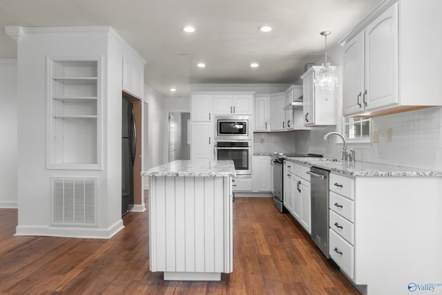3000 Eolyne Kelly Way NE, Huntsville, AL 35811 - kitchen with stainless steel appliances, light stone countertops, visible vents, and white cabinetry