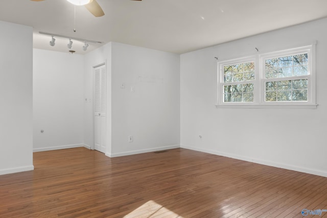 3000 Eolyne Kelly Way NE, Huntsville, AL 35811 - empty room with track lighting, ceiling fan, hardwood / wood-style flooring, and baseboards