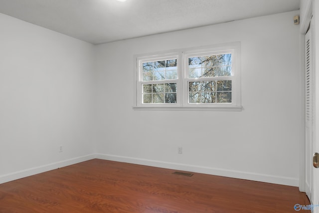 3000 Eolyne Kelly Way NE, Huntsville, AL 35811 - unfurnished bedroom featuring a closet, dark wood-style flooring, baseboards, and visible vents