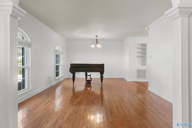 3000 Eolyne Kelly Way NE, Huntsville, AL 35811 - dining area featuring a chandelier, crown molding, light wood-style floors, decorative columns, and built in shelves
